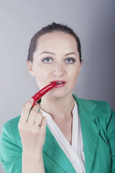 Businesswoman holding red chilli pepper — Stock Photo, Image