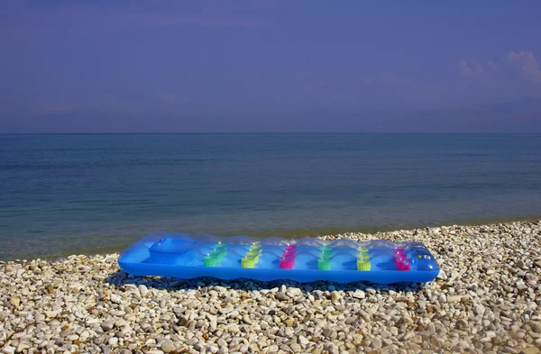 Luftmadrass på den steniga stranden — Stockfoto