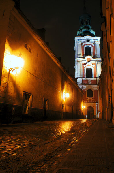 Paved street after the rain, at night in Poznan