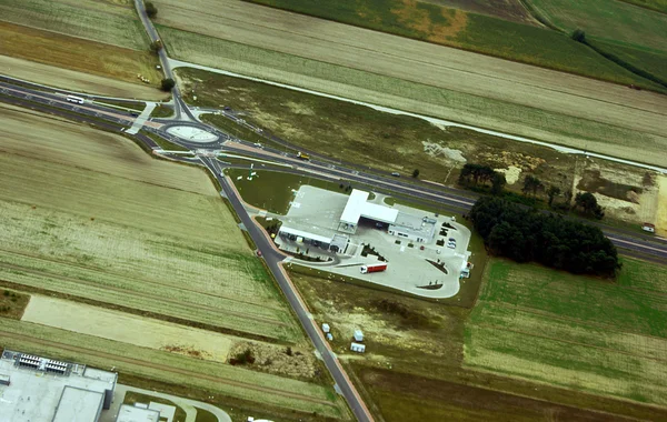 A estrada, edifícios e campos cultivados vista aérea — Fotografia de Stock