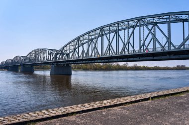 The Vistula River and the steel structure of the road bridge in the city of Torun, Poland
