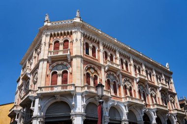 facade of a historic townhouse with balconies and shutters in the city of Padua, Italy
