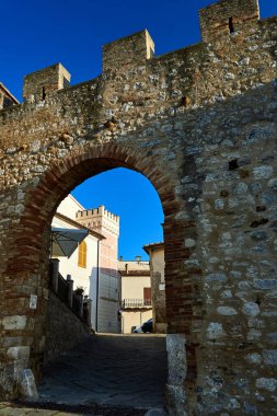 Gate with medieval ramparts in the town of Magliano in Toscana in Tuscany, Italy