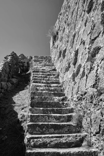 Stone stairs in the medieval Venetian castle of St George\'s on the island of Kefalonia in Greece, monochrome