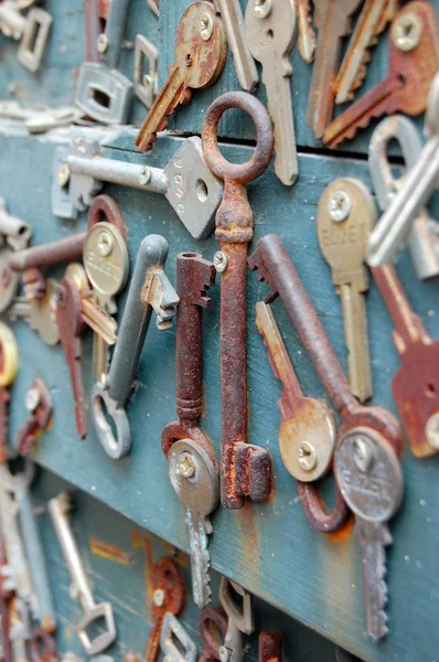 Antique rusty  keys on old wooden door — Stock Photo, Image