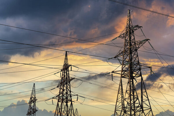 Power lines against dramatic sky. Energy transportation and lack of energy concept