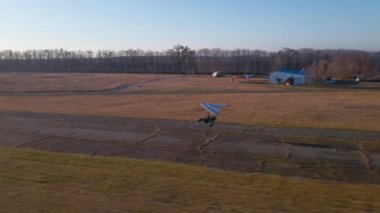 Motorized hang glider trike take off from the airfield
