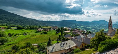 Beautiful panorama of green meadows in the French Alps near Lac de Serre-Poncon. Popular summer travel destination in Provence 
