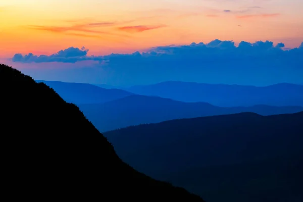 Colorful mountain silhouettes at the sunset. Vibrant mountain photo composition