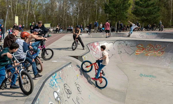 Skateboard and cyclists in a skate pool in the amusement park at Gleisdreieck Park in Berlin-Mitte, Germany