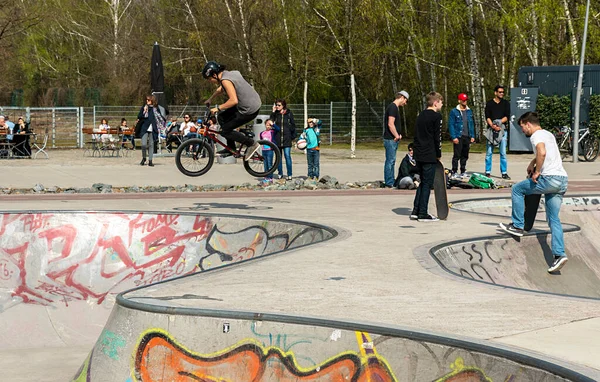 Skateboard and cyclists in a skate pool in the amusement park at Gleisdreieck Park in Berlin-Mitte, Germany