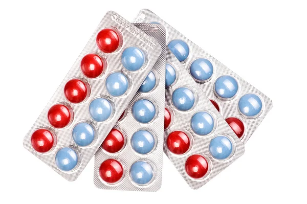 Paks de píldoras rojas y azules — Foto de Stock