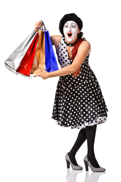 Grappige mime in vlekkerige jurk bedrijf shopping tassen — Stockfoto