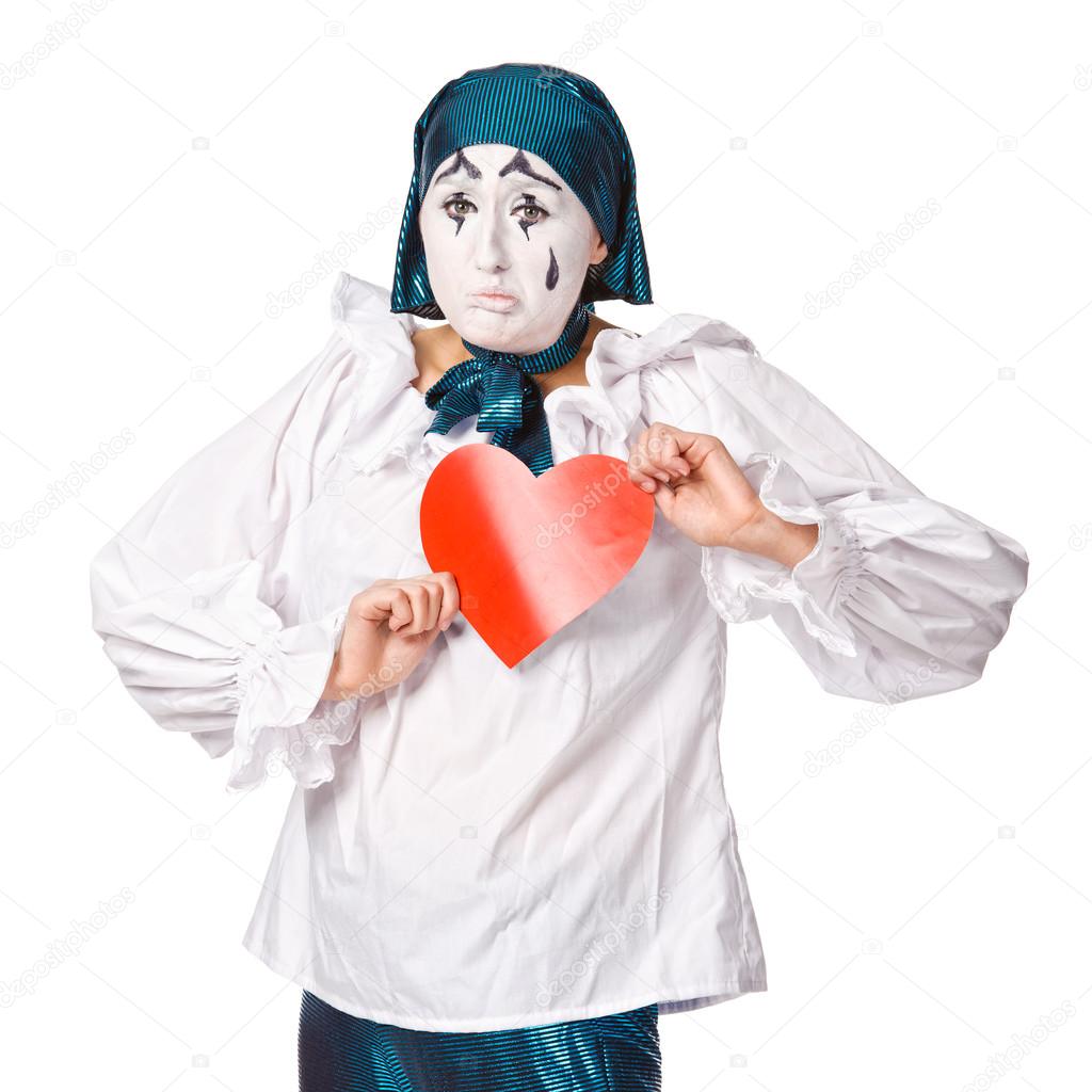 A sad female mime clown with a red heart