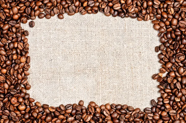 Koffie bean op jute textuur — Stockfoto