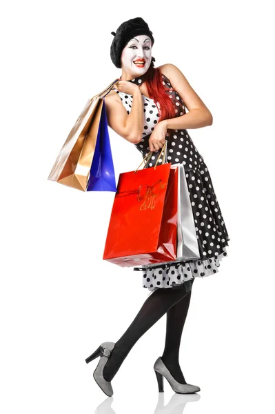 Krásný mime v flekatá šatech drží nákupní tašky — Stock fotografie