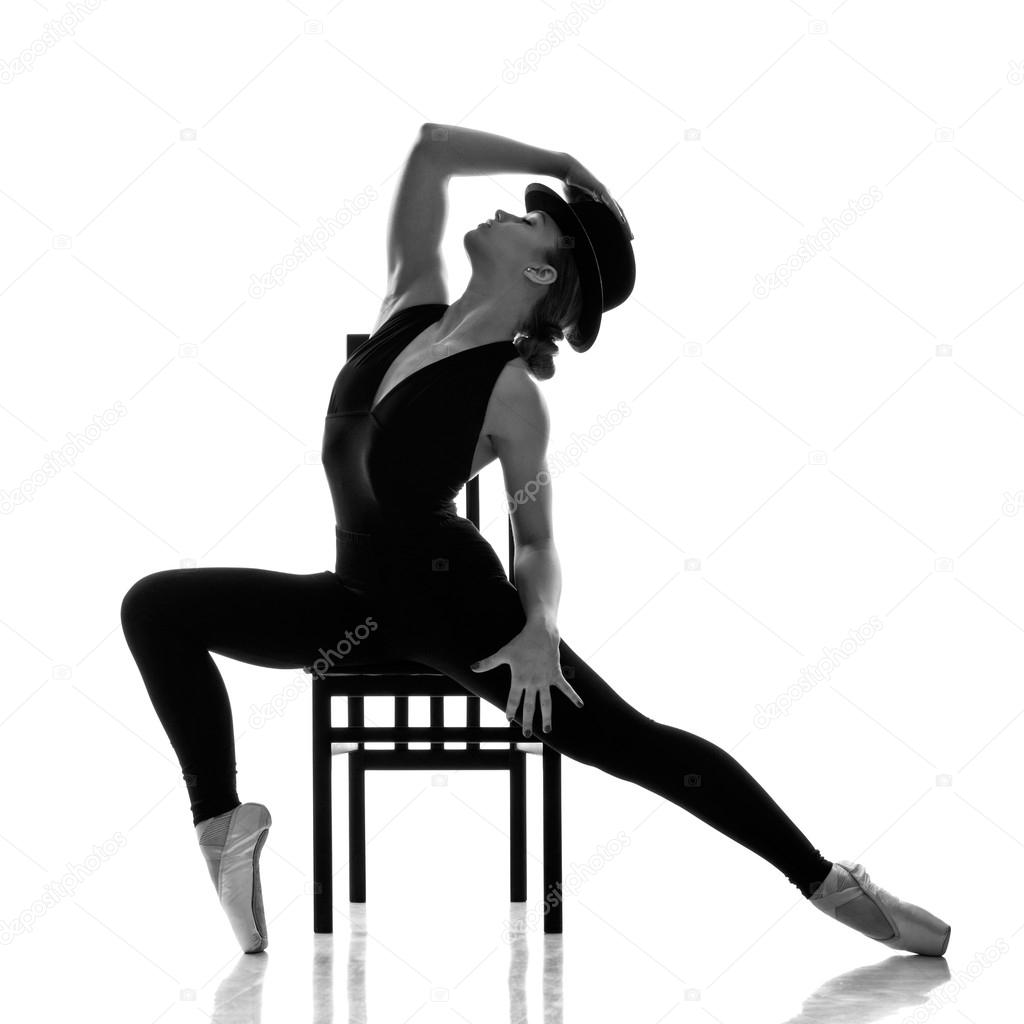 Young modern ballet dancer posing on the chair
