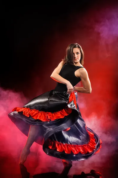 Young woman dancing flamenco on red fog — Stock Photo, Image