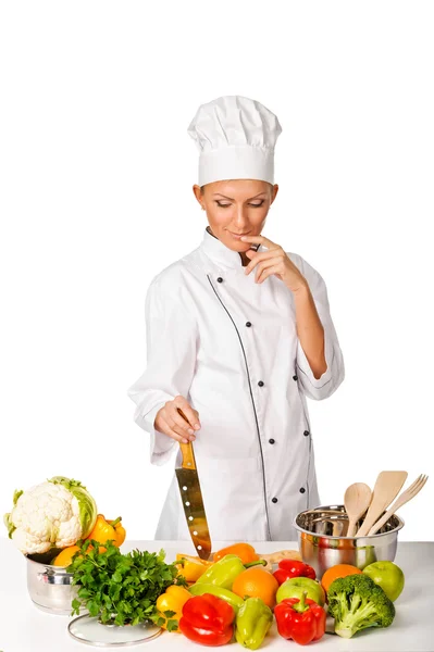 Young attractive woman chef thinking. Variety of fresh vegetabl — Stock Photo, Image