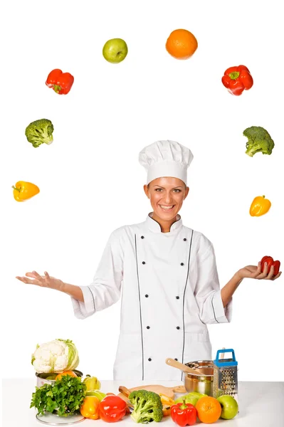 Woman chef juggling with fresh vegetables. Isolated — Stock Photo, Image
