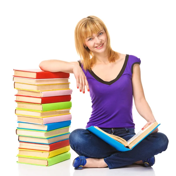 Lovely student sitting on a floor with stack of books, isolated — Stock Photo, Image