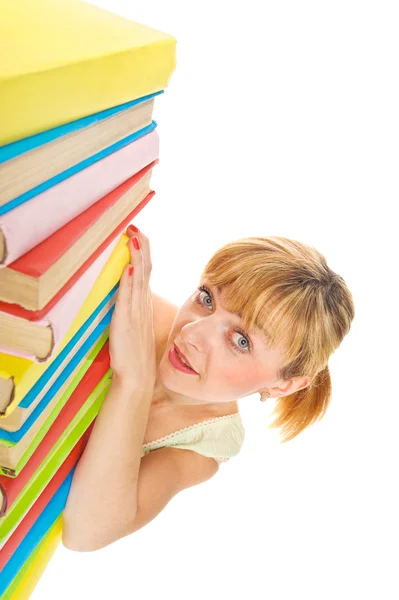 Chica feliz con apilar libros de color. Aislado Imágenes de stock libres de derechos