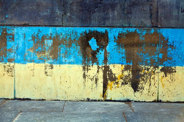 Wall element in the urban infrastructure of Kyiv, painted in the colors of the national flag of Ukraine. Blue and yellow