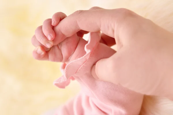 Dziecko za rękę trzyma palec matki — Zdjęcie stockowe