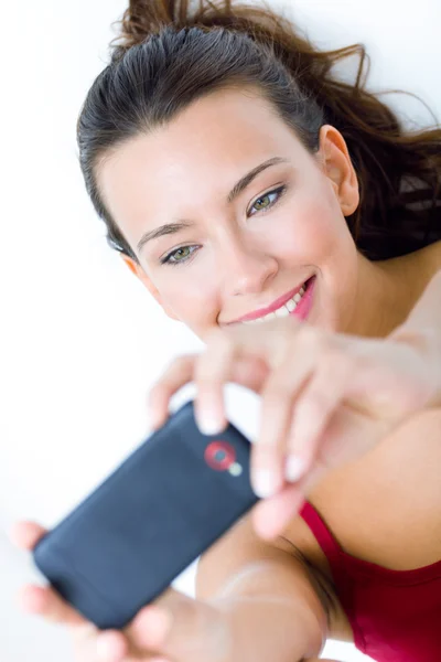 Cute brunette woman taking photo of herself — Stock Photo, Image