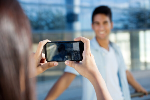 Young couple taking photos with mobile