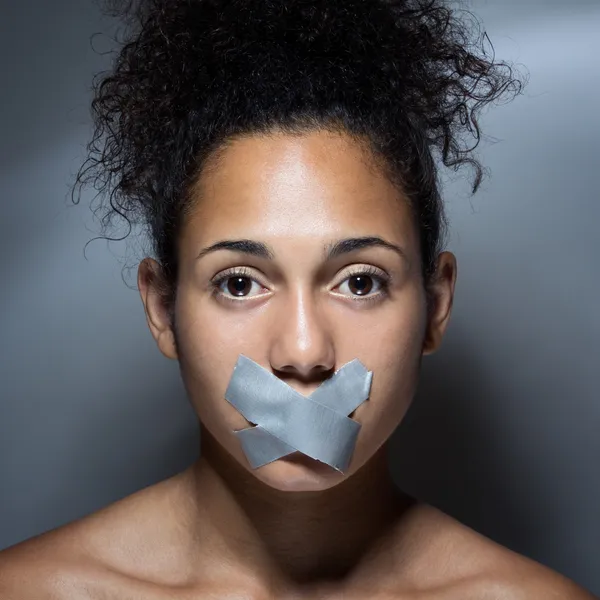 Black woman with mouth covered with tape — Stock Photo, Image