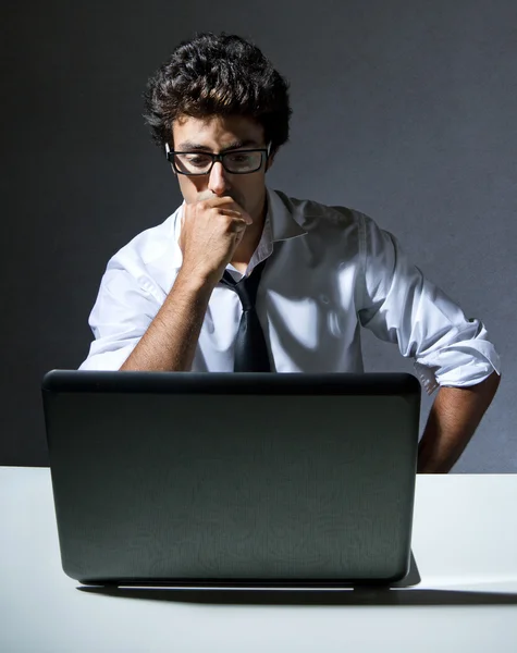 Executive thinking in front of his laptop — Stock Photo, Image