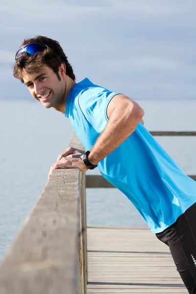 Young man doing push ups near the sea — Stock Photo, Image