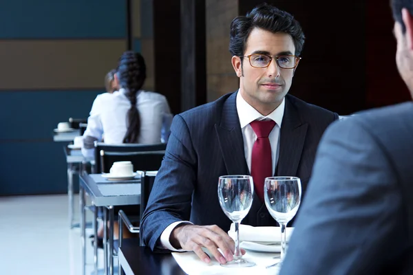 Two smiling business men have dinner at restaurant — Stock Photo, Image