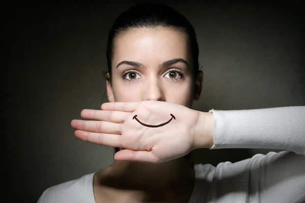 Young girl crying with her hand covering her mouth — Stock Photo, Image