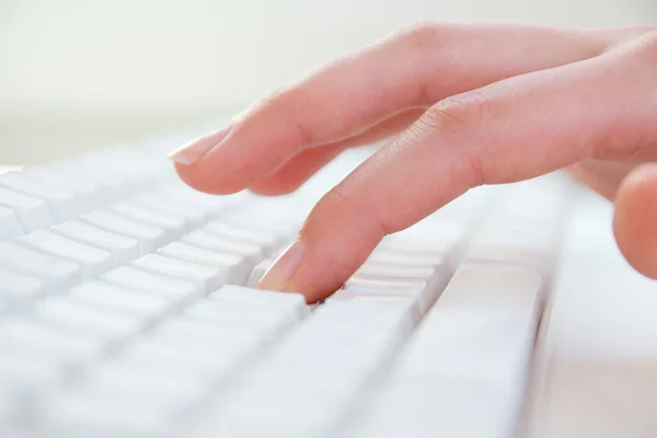 Hands typing on keyboard in the workplace Stock Photo