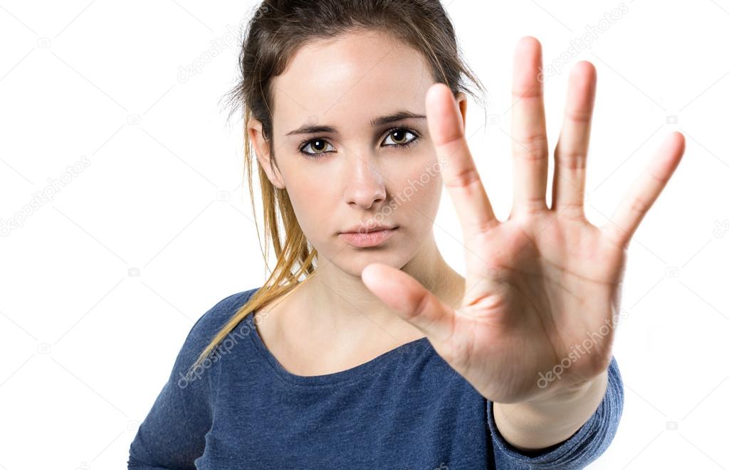 Young woman making stop sign in front of the camera