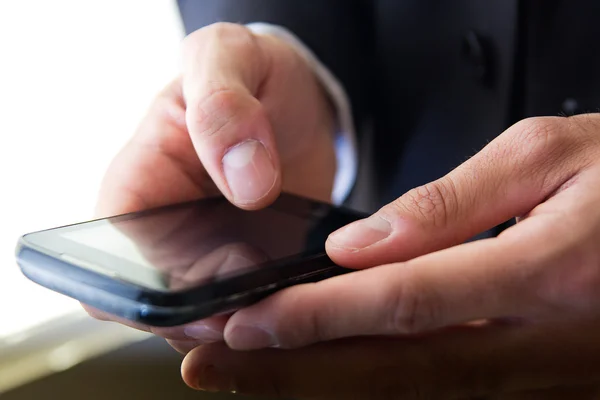 Hand's detail of Businessman using a samrtphone — Stock Photo, Image