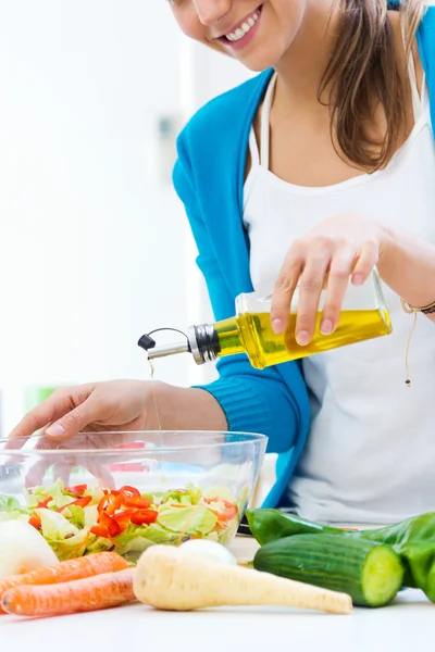 Pretty young woman cooking at home — Stock Photo, Image