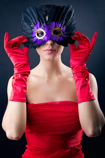 Sophisticated woman with red dress and carnival mask — Stock Photo, Image