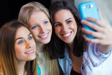 three friends taking photos with a smartphone clipart