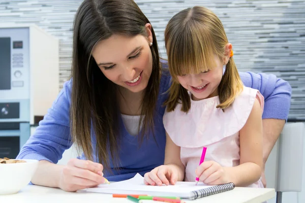 Criança desenho com lápis de cera com sua mãe em casa — Fotografia de Stock