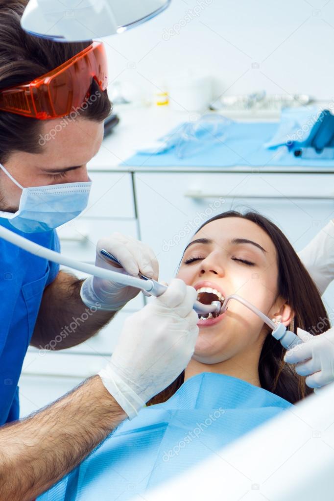 Cute young woman at the dentist. Mouth checkup