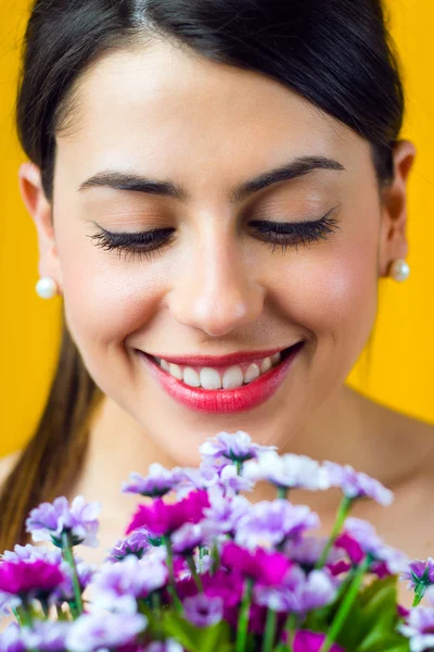 Happy young girl with flowers — Stock Photo, Image