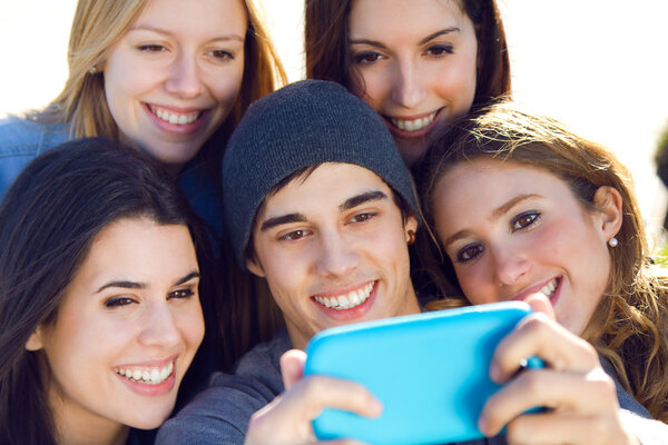 A group of friends taking photos with a smartphone