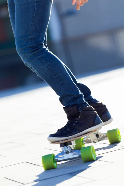 Legs of young boy skating down the street — Stock Photo, Image