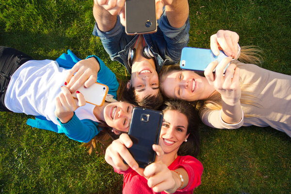 A group of friends taking photos with a smartphone