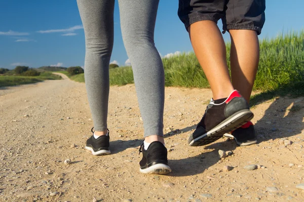 Detail of couple legs walking on the field — Stock Photo, Image