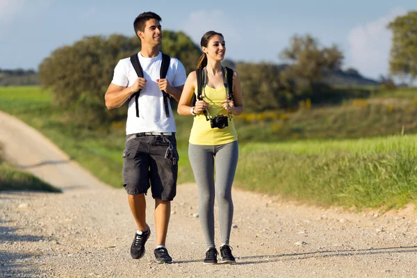 Happy Young couple on the field in spring — Stock Photo, Image