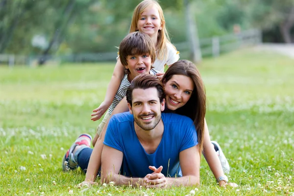 Happy young Family lying on grass — Stock Photo, Image